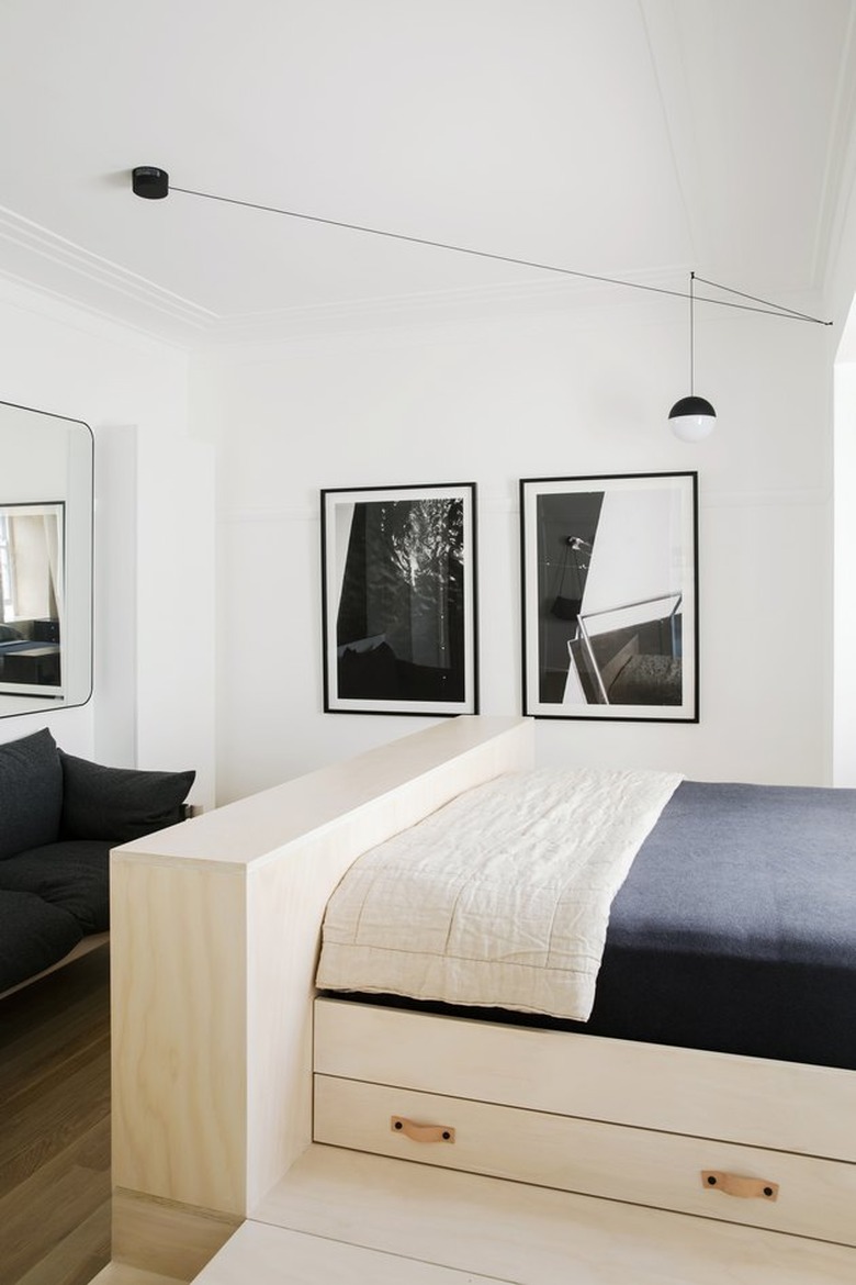 bedroom living room area with built-in plywood under bed storage