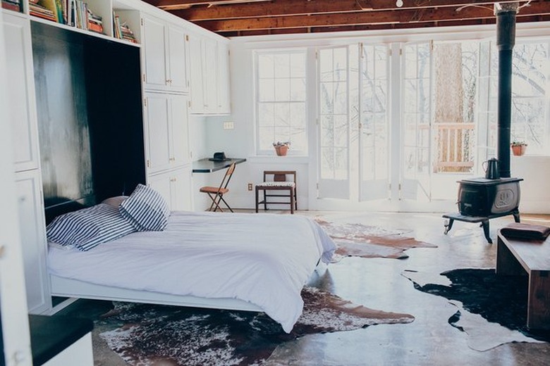 cottage bedroom with Murphy bed and wood-burning stove