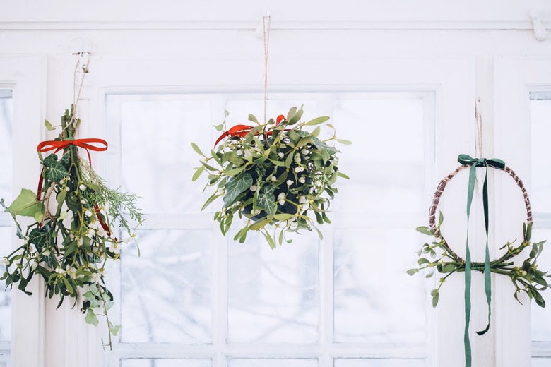 a mistletoe wreath, ball, and traditional hanging cluster all mounted on a ceiing