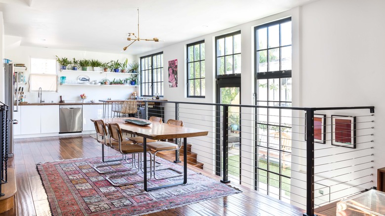 Modern dining room with boho rug and kitchen