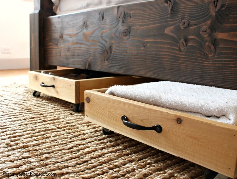 Cedar rolling drawers beneath a bed