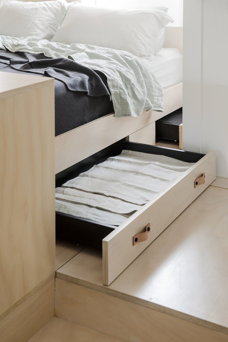 A built-in drawer beneath a bed