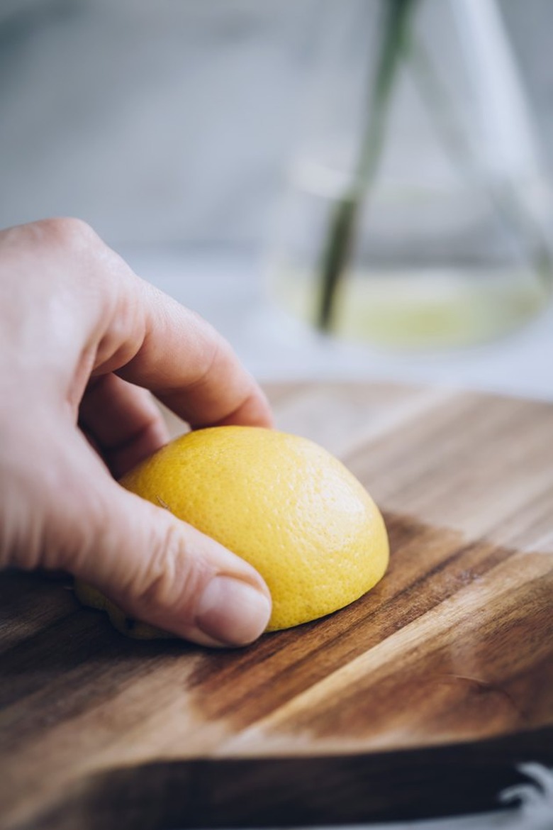 Cleaning a wood cutting board with lemon