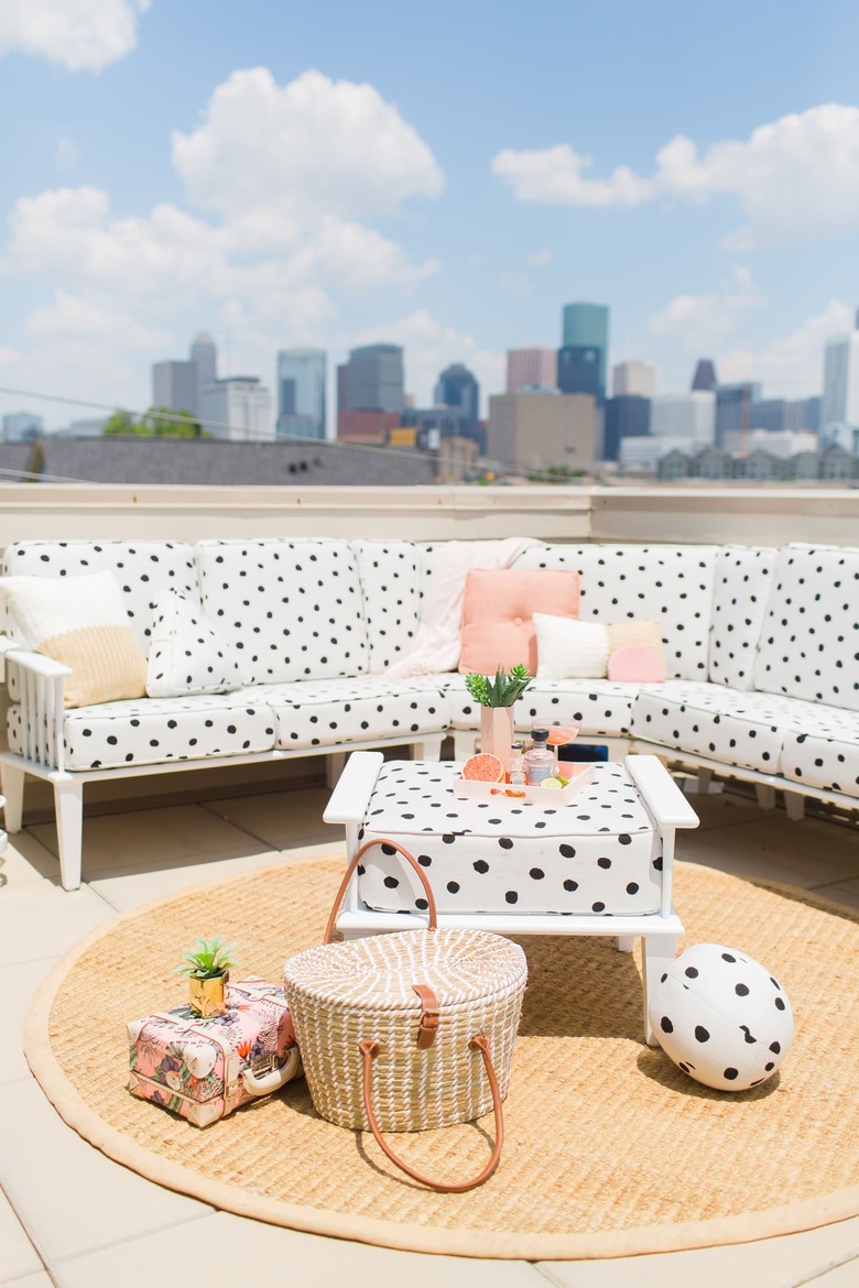 rooftop outdoor patio seating area with sectional sofa and round area rug