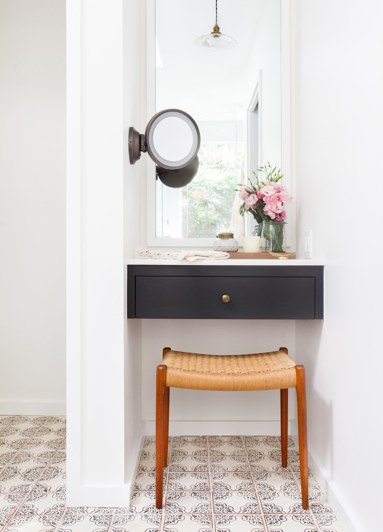 patterned bathroom floor tile idea with floating black vanity and white walls