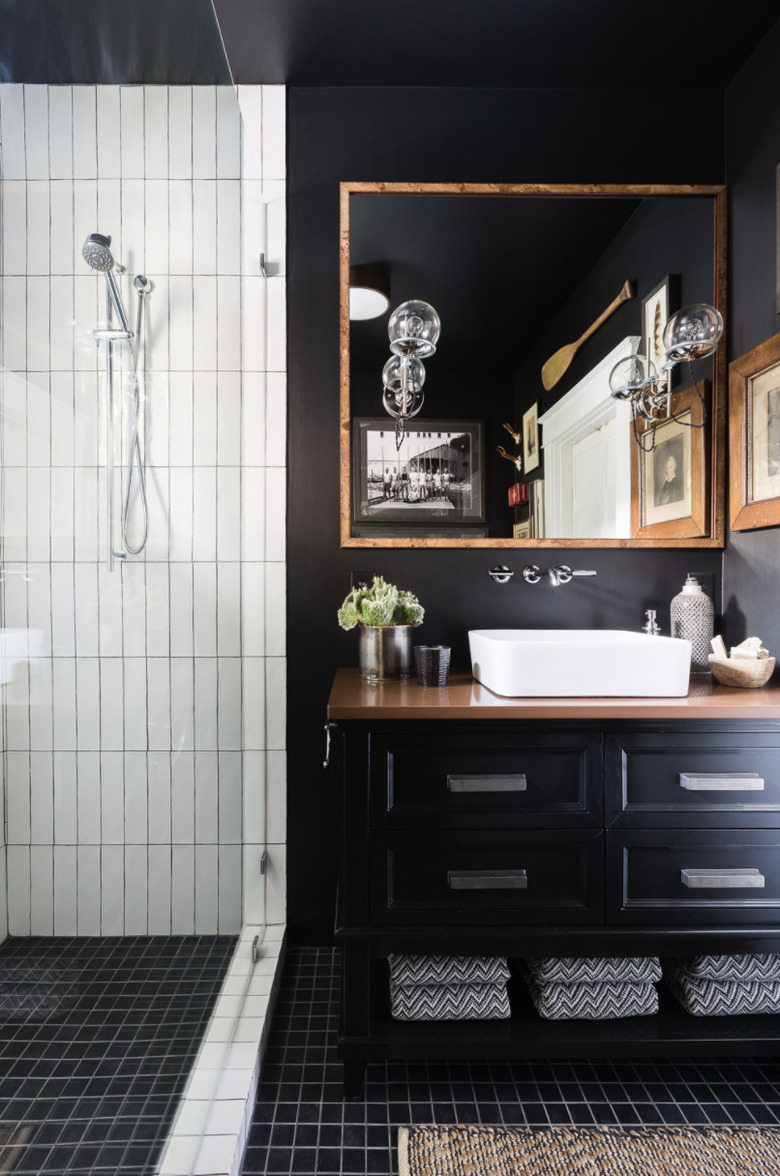 black walls with black flooring and black vanity cabinet