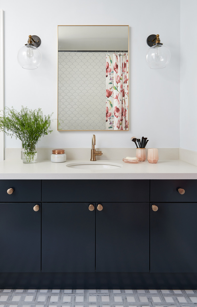 black bathroom vanity with bronze hardware