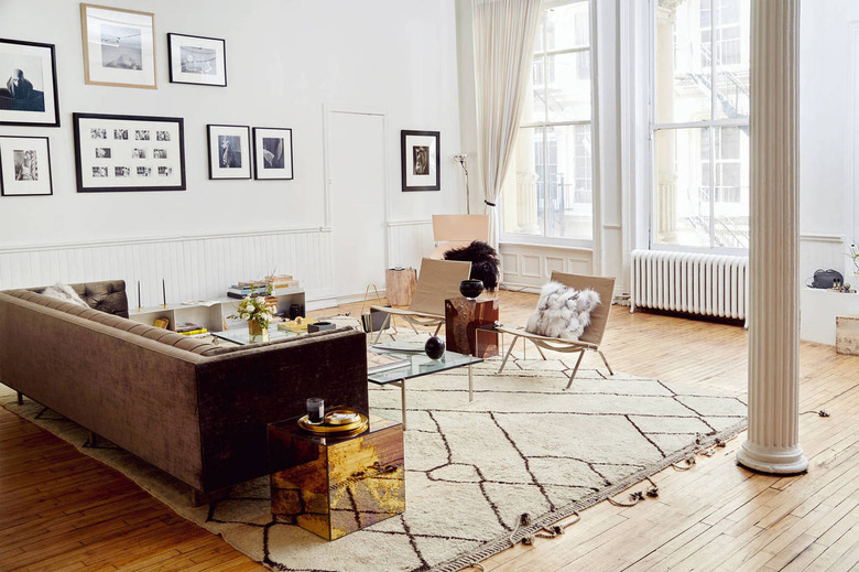 A light-filled apartment with two large windows and a living room.