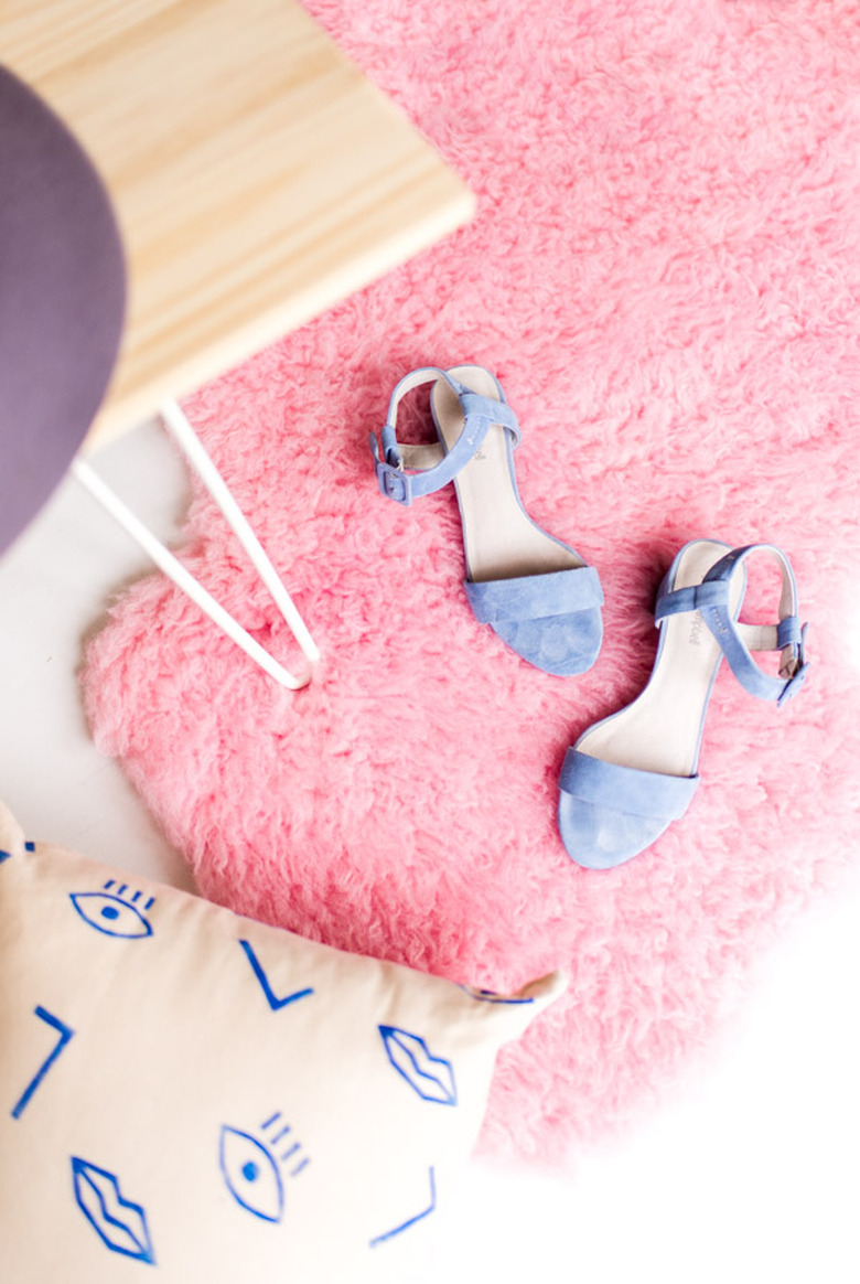 A pink rug with shoes on it