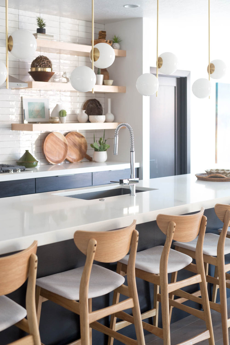 modern kitchen lighting idea paired with blue cabinets and open shelving