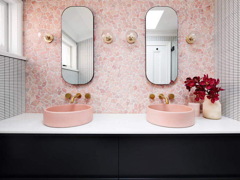 Millennial pink bathroom sink idea with pink backsplash and black vanity cabinet