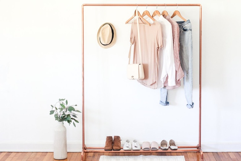 a clothing rack with a shoe rack attached made from copper pipe