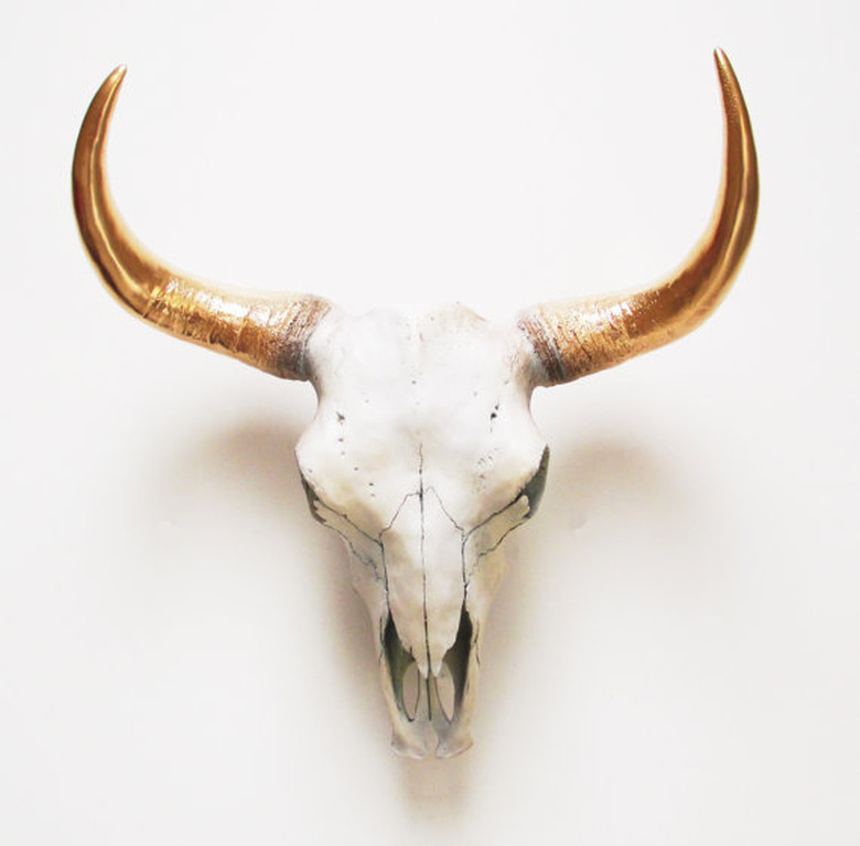 faux animal skull with gold horns