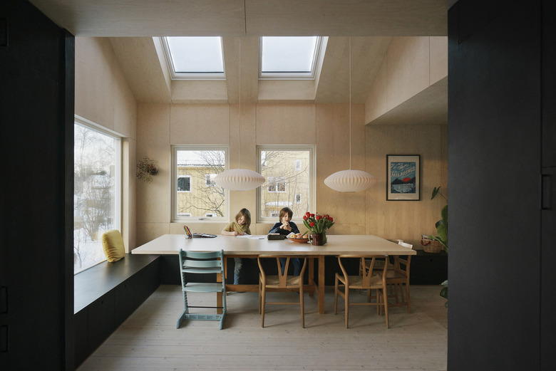 dining room with wood walls