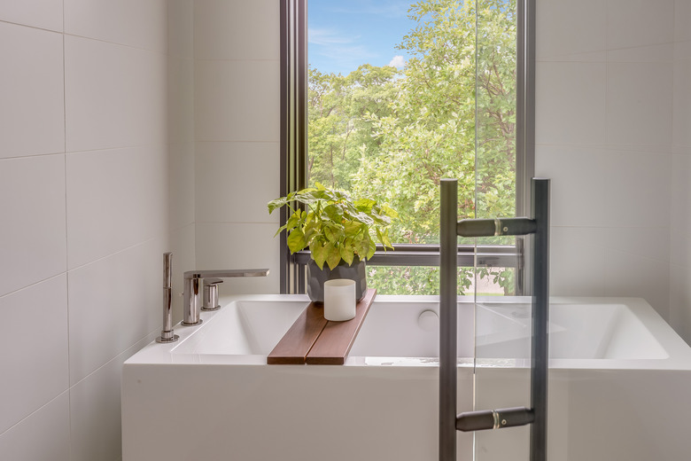 Bathtub enclosed within the shower of new modern home