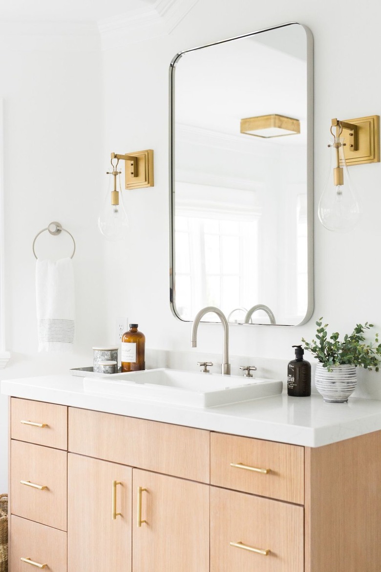 self-rimming bathroom sink with wood vanity and white countertop