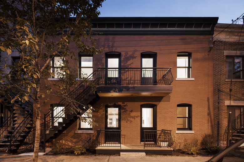 Brick front with balcony at night