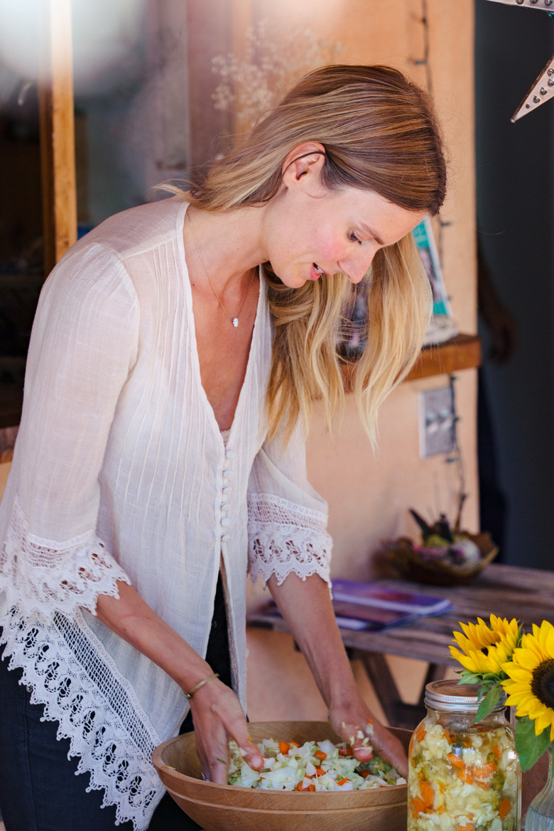 Shot of Colleen mixing a batch of sauerkraut on the patio