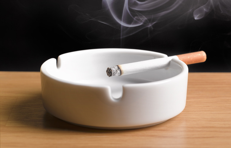 lit cigarette, burning in ashtray