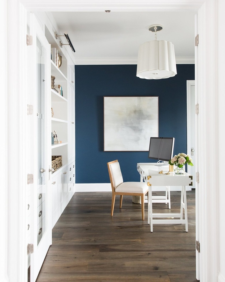 home office with navy blue accent wall