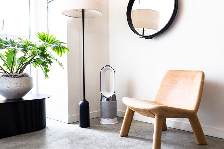 Air purifier in room with white walls, gray floors, and minimalist furnishings