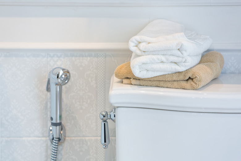 Towels on top of a toilet