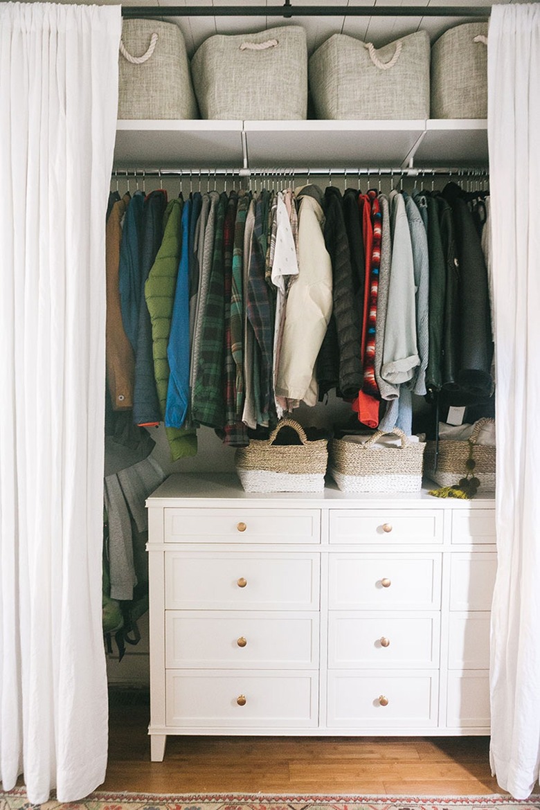 Bedroom with curtains for closet door.