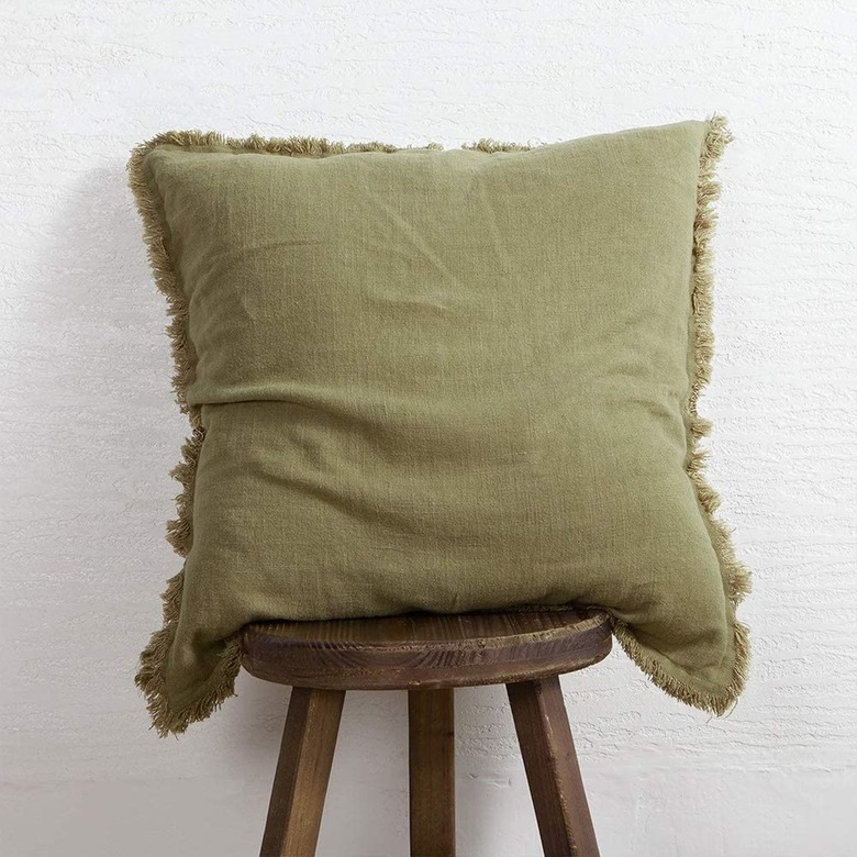 soft green linen pillow on stool