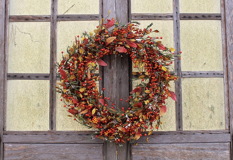 wreather with leaves and berries on door