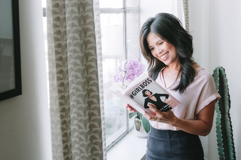 Anna Marie Cruz holding a book by a window