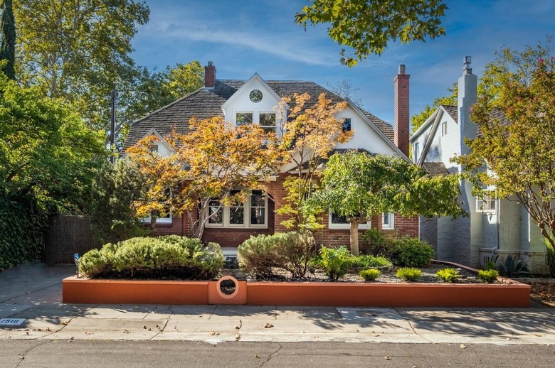 Exterior of a brick house with front yard