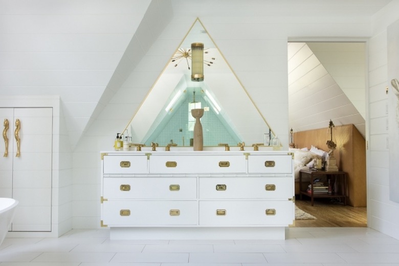 white apartment bathroom idea in A-frame space with brass details