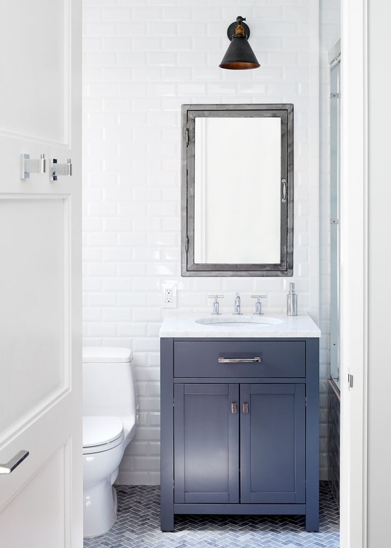 apartment bathroom idea with blue vanity and white walls