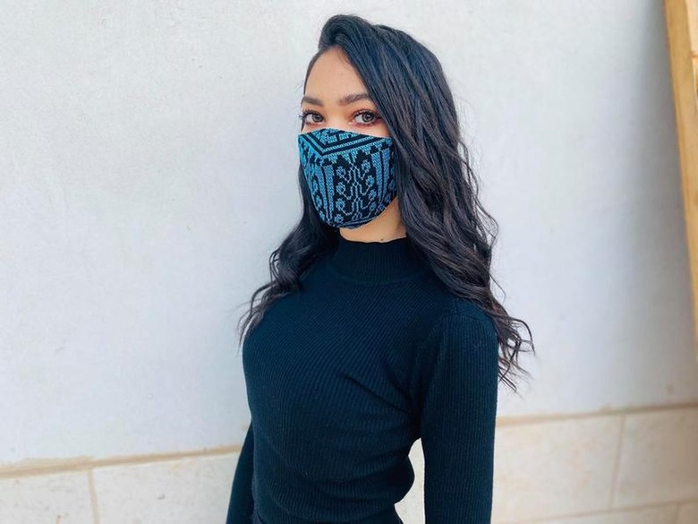 person with blue mask and black shirt