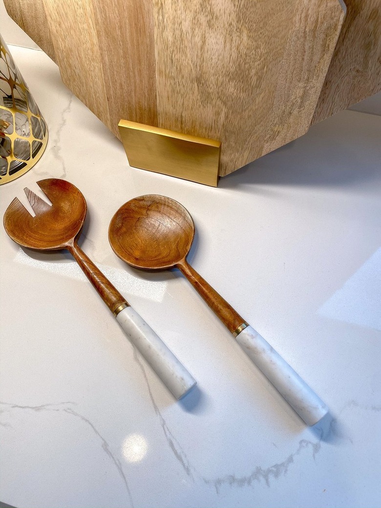 two wood serving spoons with marble handles