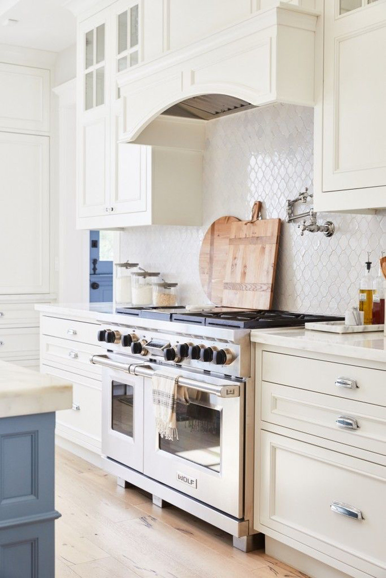 white kitchen with white arabesque tile backsplash