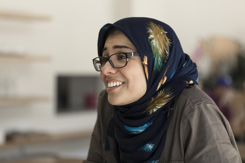 maryam eskandari smiling, wearing  glasses and a headscarf