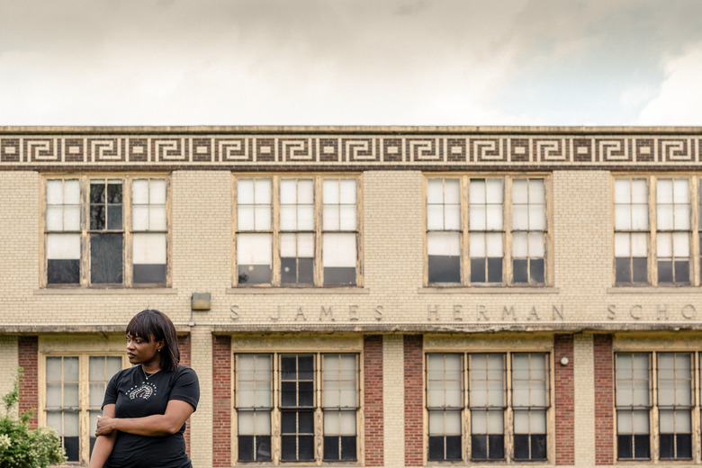 Tiffany in front of Herman Gardens high school