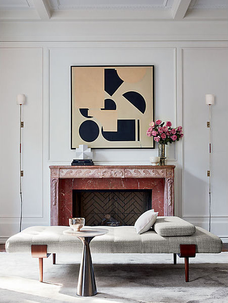 art deco apartment with white living room with fireplace and large wall art