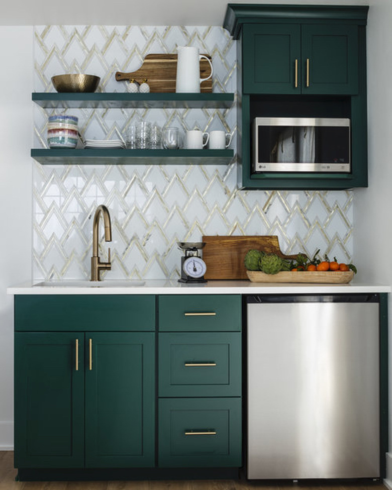 art deco backsplash with green cabinets in small kitchen