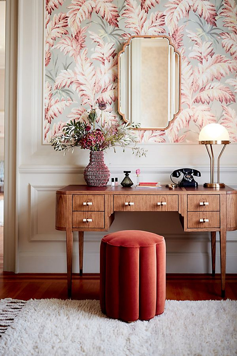 art deco colors with blush and brass with patterned wallpaper and wood desk