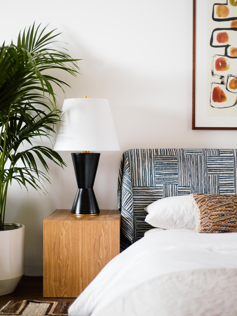 art deco colors in bedroom with black lamp and neutral bedding