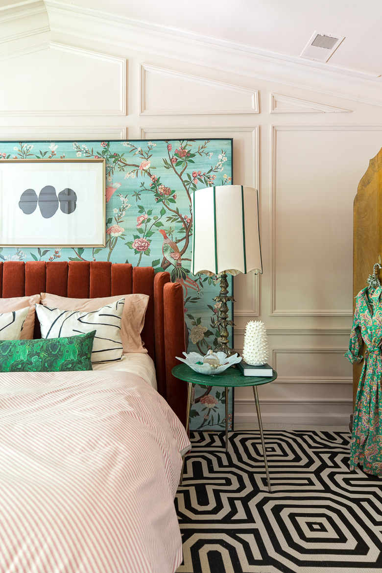 art deco colors in bedroom with black and white geometric carpet and floral turquoise mural