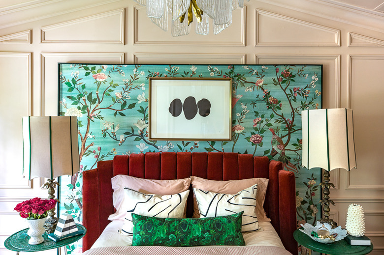 art deco bedroom with layered patterns and floral wall mural