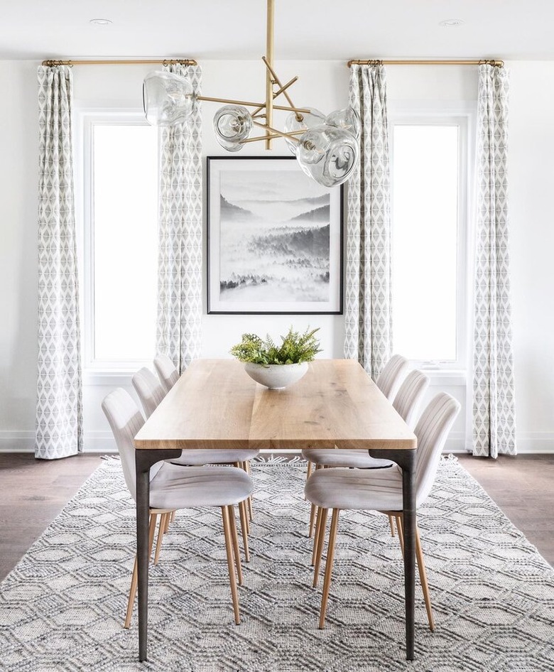 Modern neutral art deco dining room with glass and brass chandelier