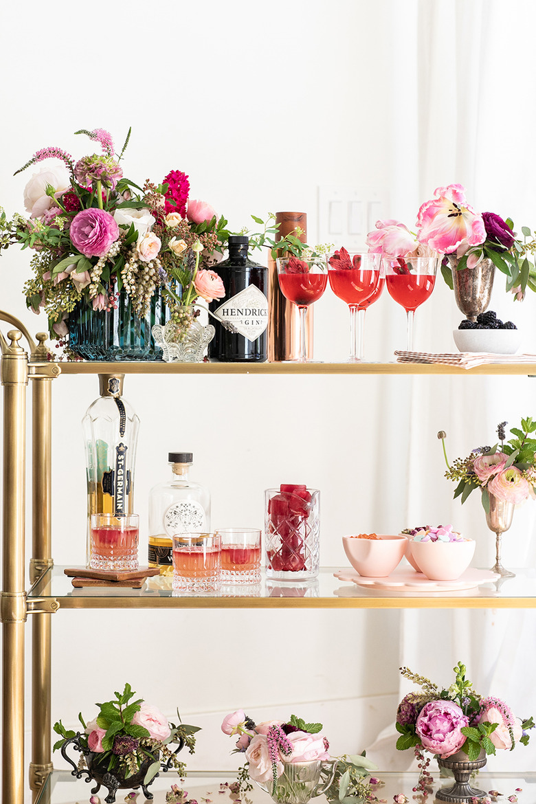 art deco themed party idea with bar cart with flowers