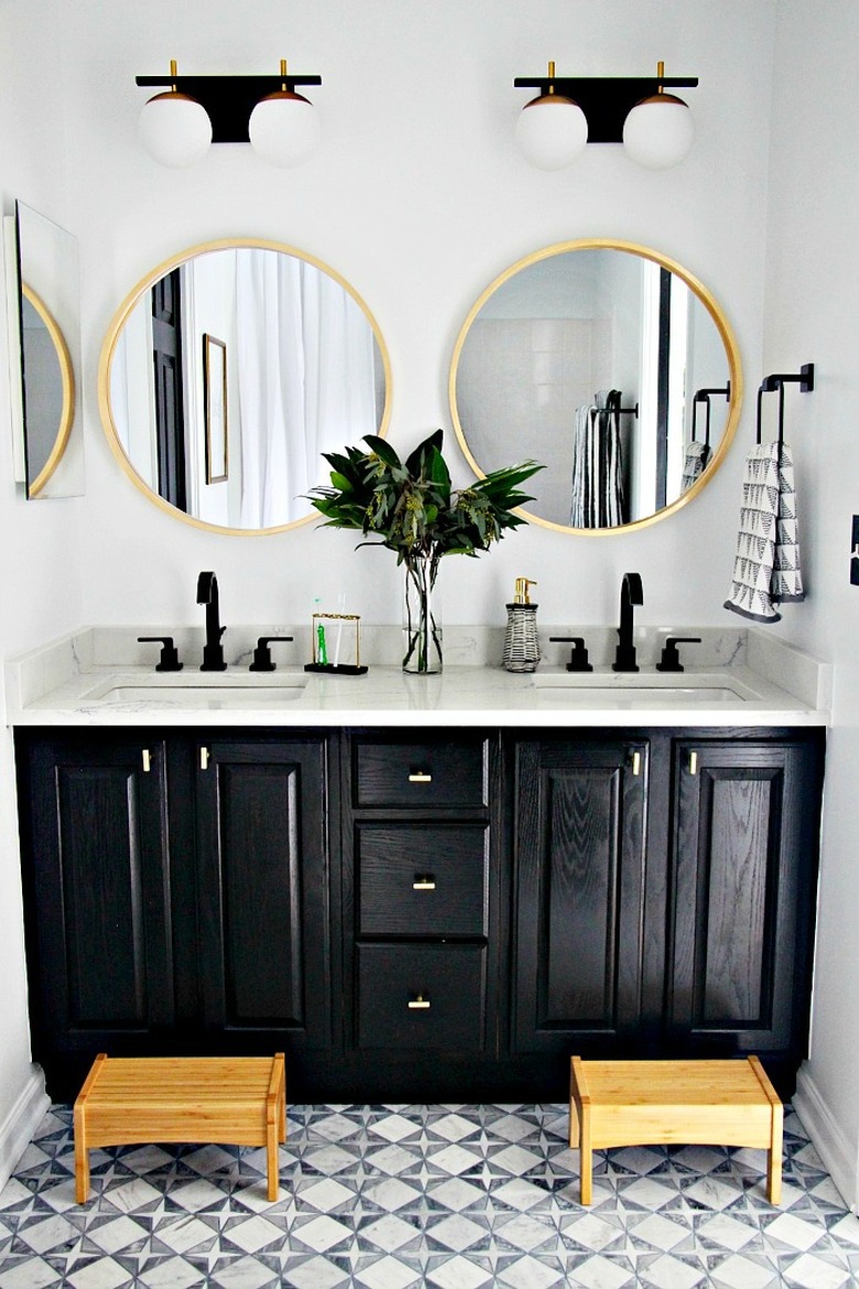 Star-shaped art deco tile floor with black cabinets in modern bathroom