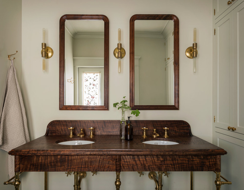 arts and crafts bathroom with vintage-inspired console vanity with brass hardware and lighting