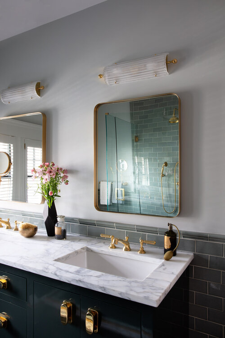 arts and crafts bathroom with brass hardware and marble countertop