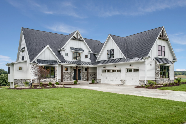 Large house with steep roof and side entry three car garage